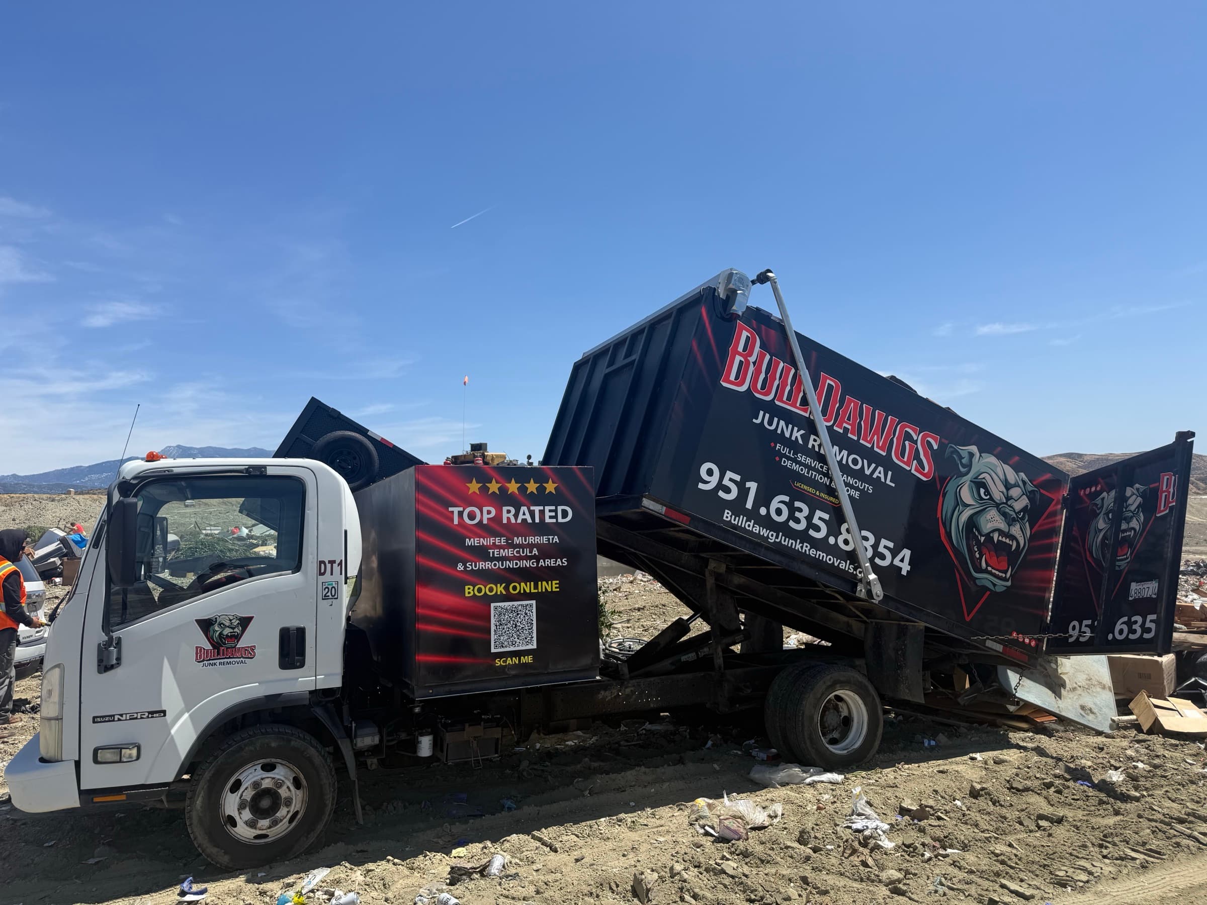 BullDawgs 18-yard dump truck unloading at a transfer facility