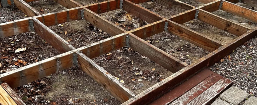 Broken wooden deck frame prepared for demolition hauling