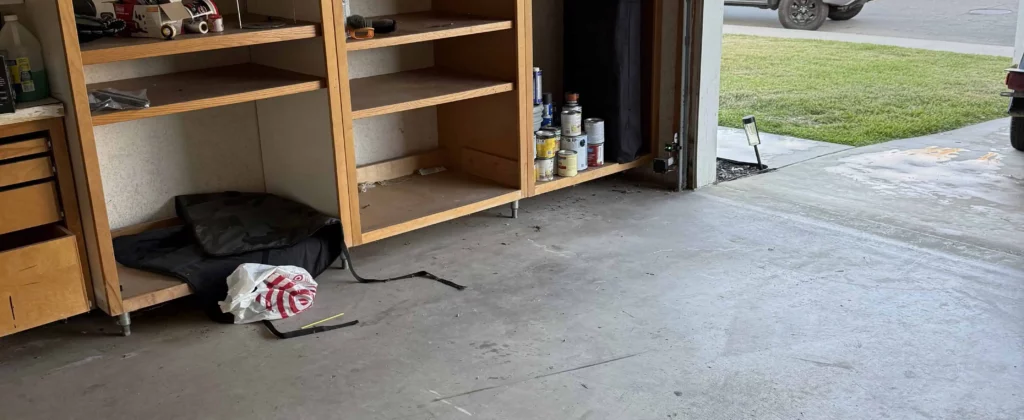 Cleared garage with shelving after junk hauling service