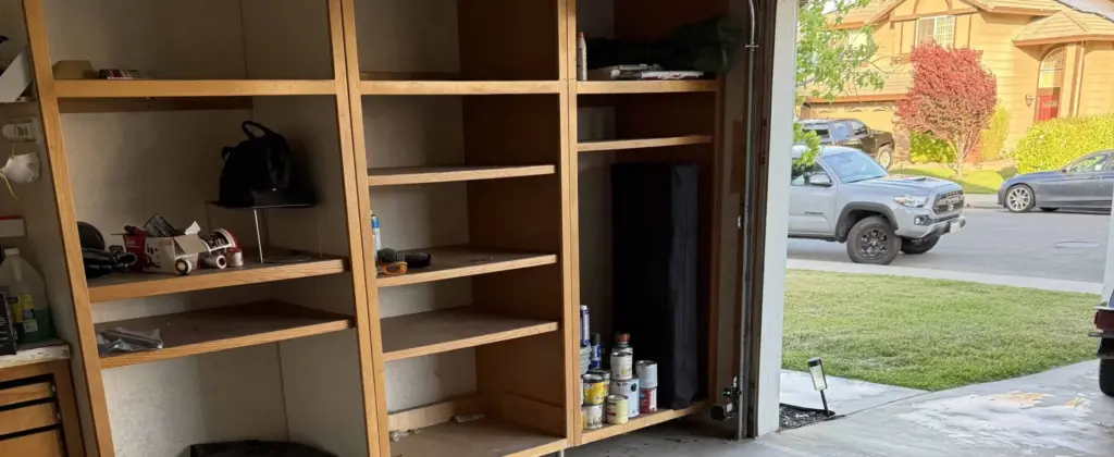 Cleared garage with shelving after junk hauling service