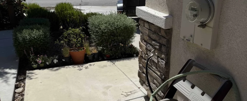 Outdoor junk and hoses piled near residential front entryway