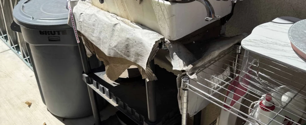 Outdoor junk pile with wires tools and old sink ready for removal