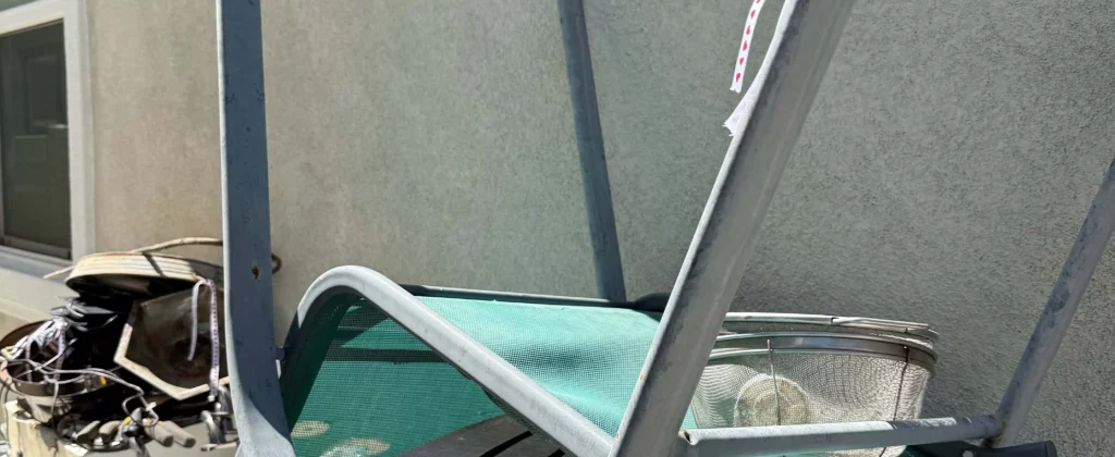 Twisted metal and patio debris staged for junk removal pickup