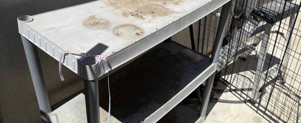 Worn plastic shelving unit outside home ready for removal