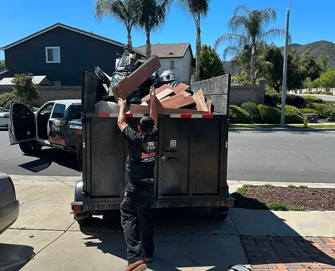 junk-removal-loading-dump-trailer-residential-area-min