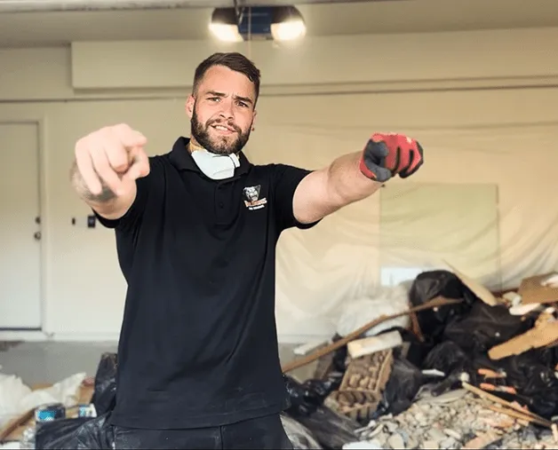 junk-removal-worker-pointing-cleanup-site