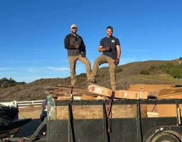 Bulldawgs crew on a loaded trash trailer